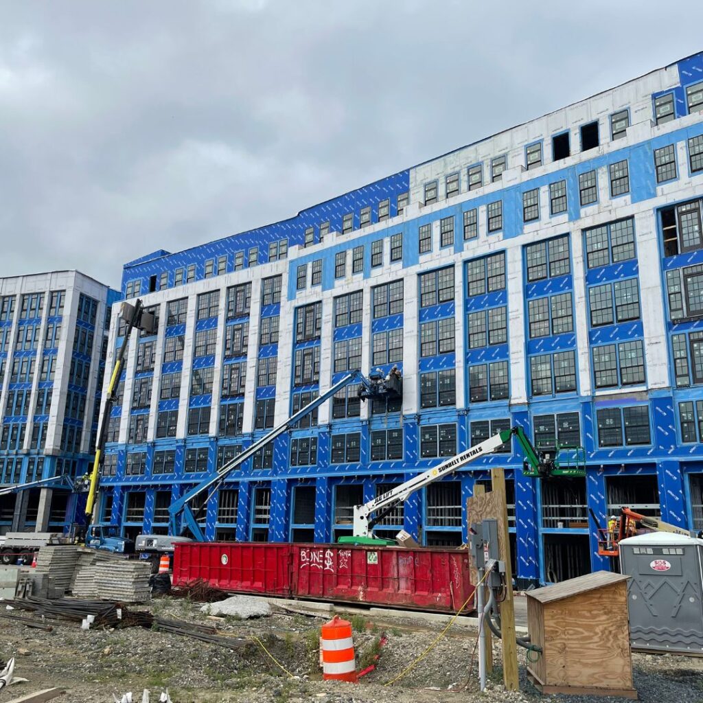 Installation of thru-wall flashing on a large commercial building.