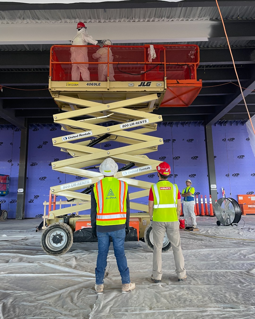 Technicians installing Hilti Fire Finish 120+ intumescent fireproofing in a commercial building